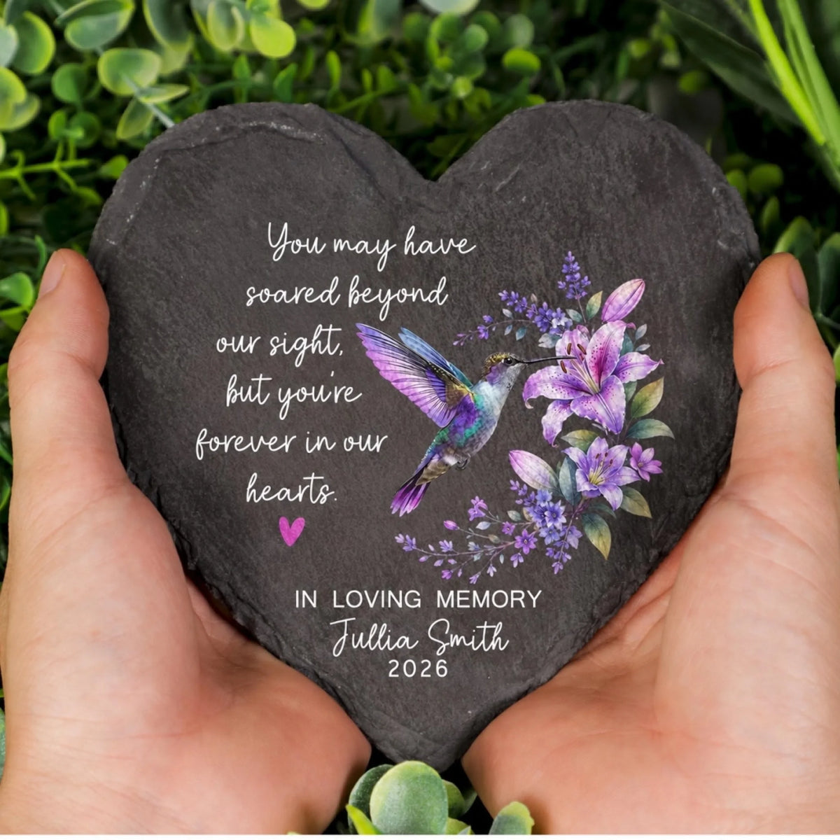 Heart memorial stone held in hands