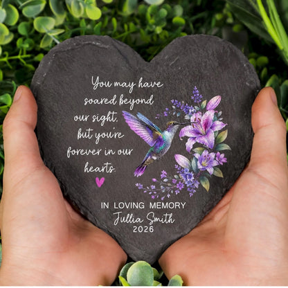 Heart memorial stone held in hands