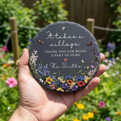 It takes a village slate stone with family name held in garden