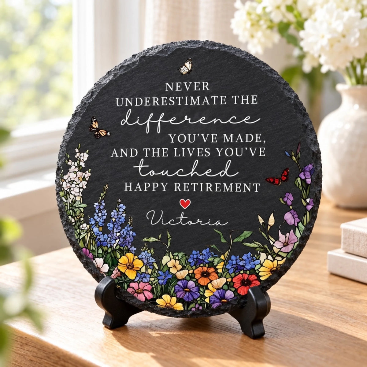 Happy Retirement round slate on desk by window