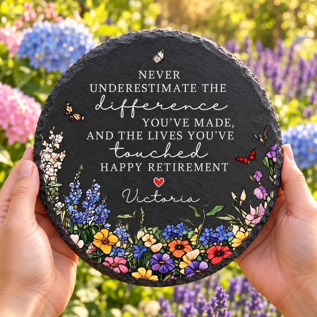 Retirement garden stone held in flower garden