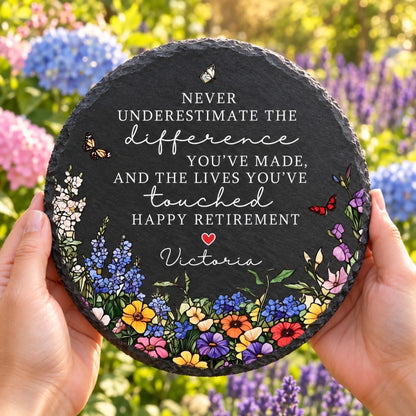 Retirement garden stone held in flower garden